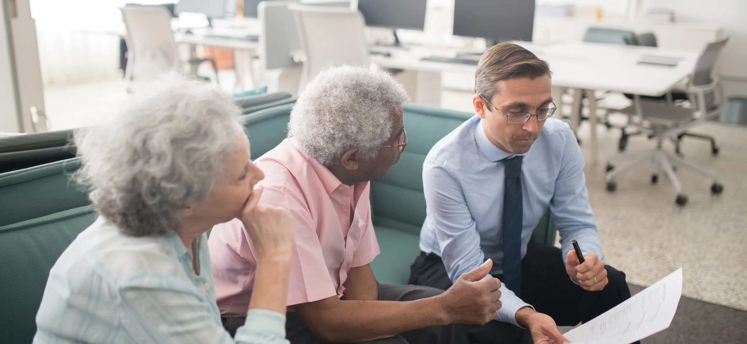 A licensed agent going through coverage options with an older couple
